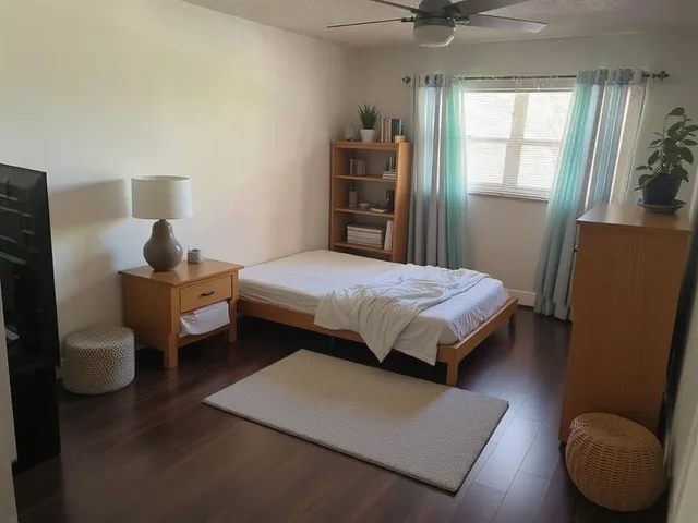 a bedroom with a bed and a window