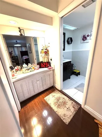 a living room with a baby crib furniture and a dresser