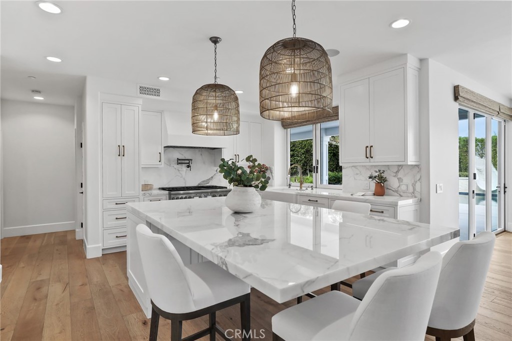 48 Panorama Coto de Caza, CA 92679 - Photo 15 of 66 a kitchen with stainless steel appliances kitchen island granite countertop a table chairs and a wooden floor