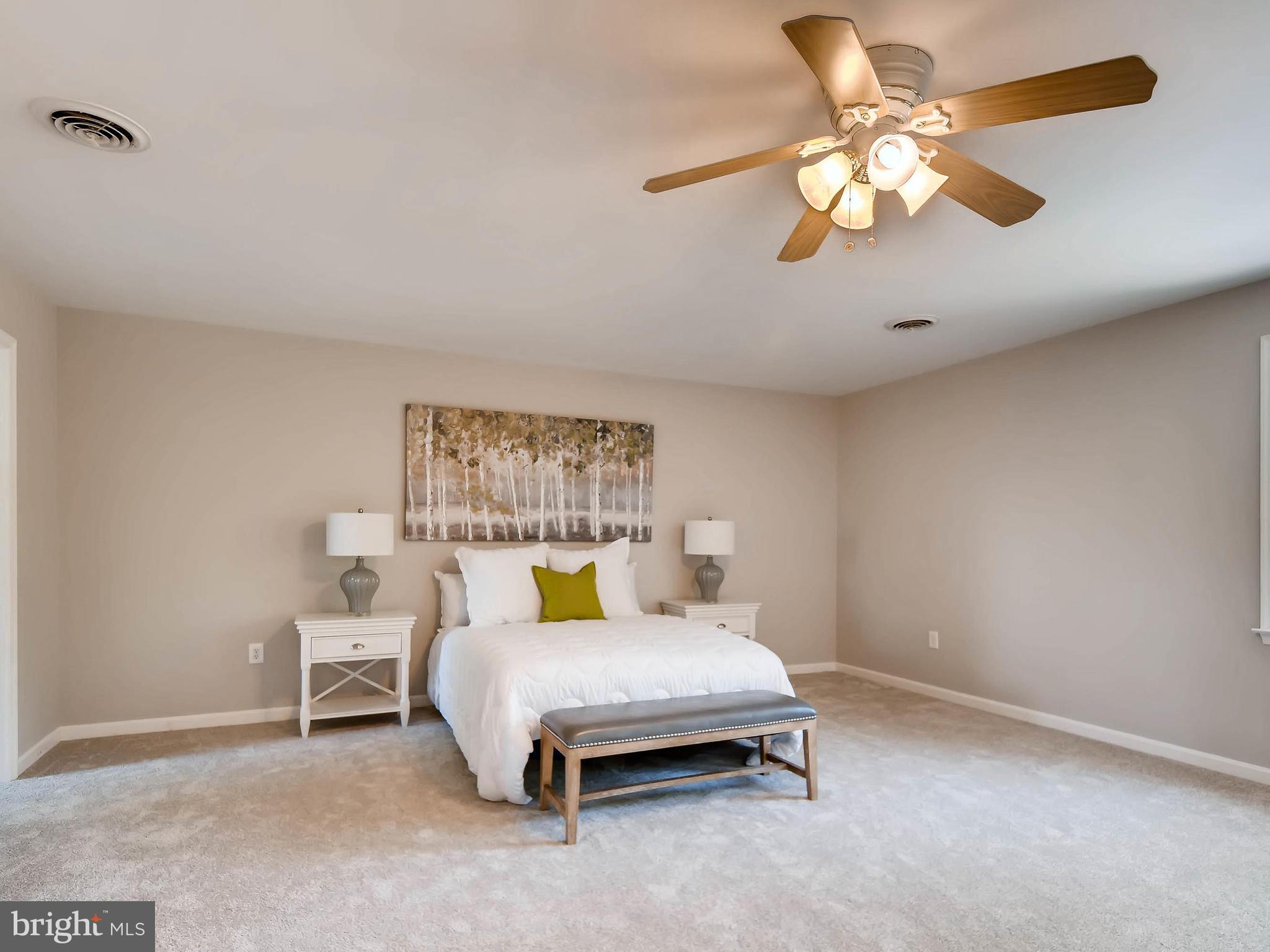 13701 Bardon Road Phoenix, MD 21131 - Photo 19 of 30 a bedroom with a bed and a chandelier