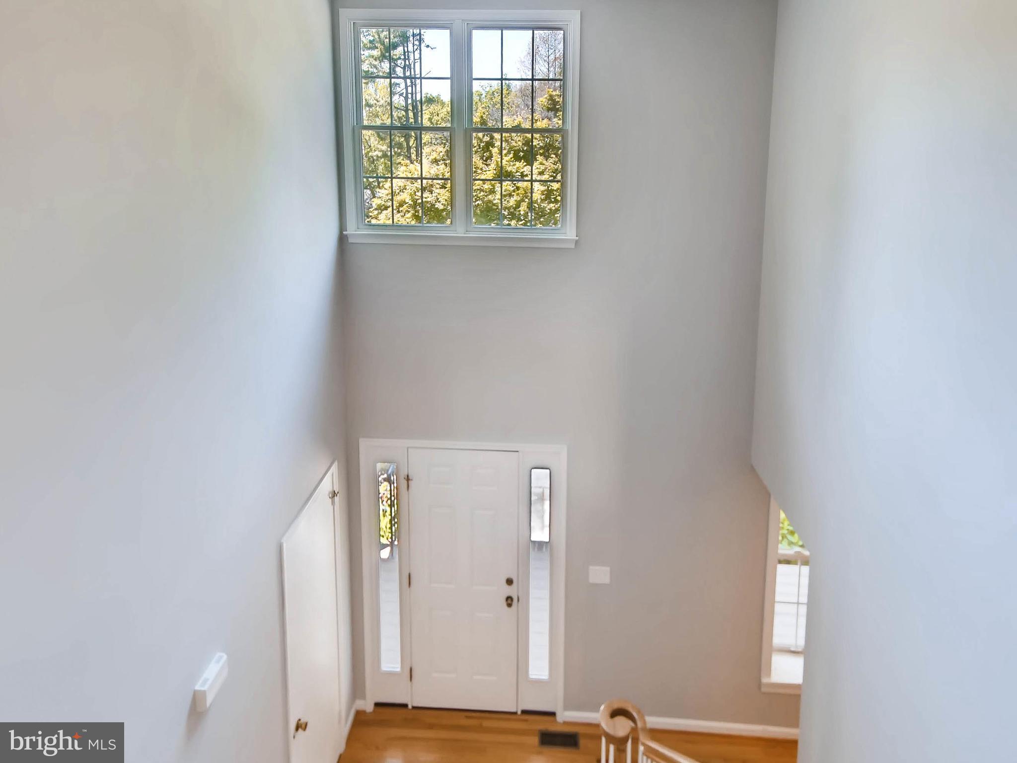 13701 Bardon Road Phoenix, MD 21131 - Photo 4 of 30 an entryway with wooden floor and a window