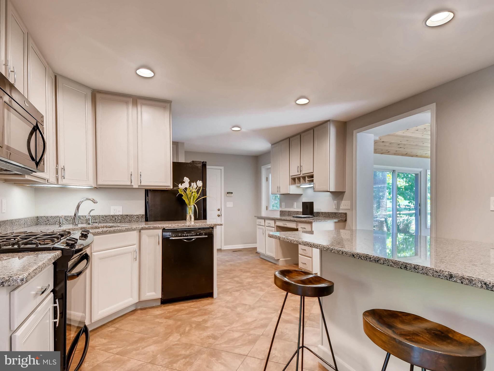 13701 Bardon Road Phoenix, MD 21131 - Photo 7 of 30 a kitchen with granite countertop white cabinets and appliances