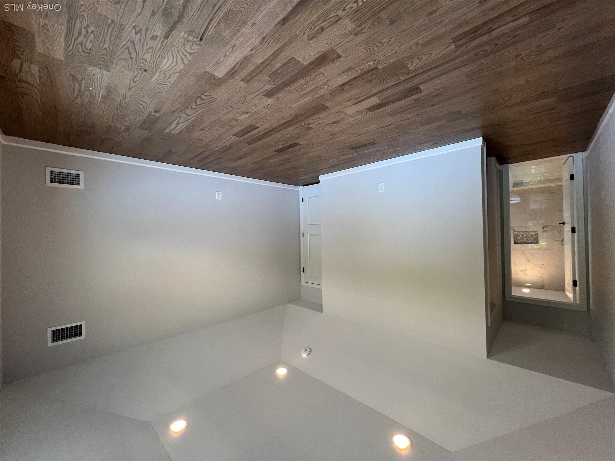 35 Babylon Road Mastic Beach, NY 11951 - Photo 17 of 19 a view of an empty room with wooden floor and a window