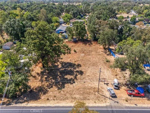 a view of a yard with wooden fence