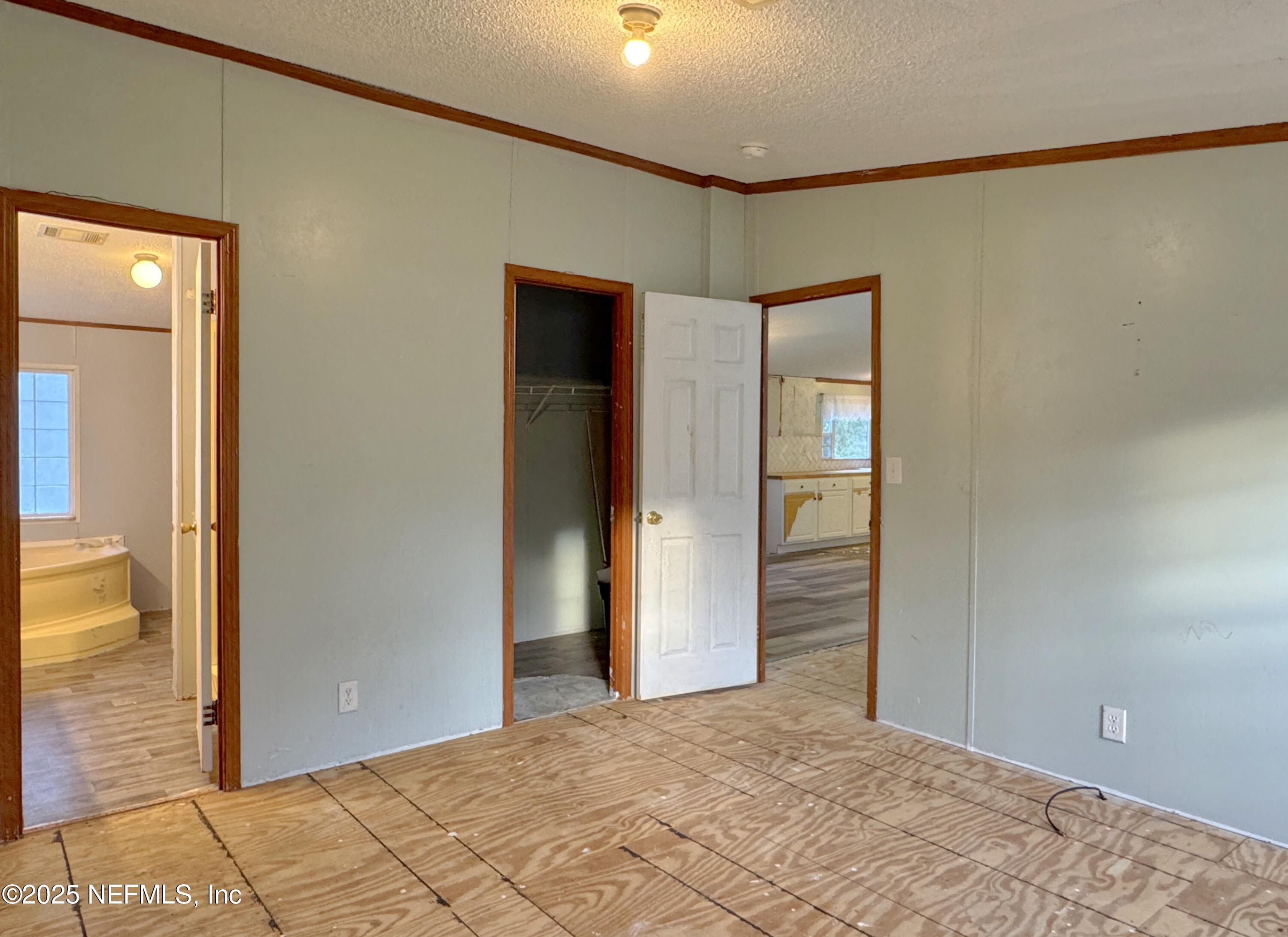 132 Long Road Interlachen, FL 32148 - Photo 11 of 21 a view of a big room with wooden floor and windows