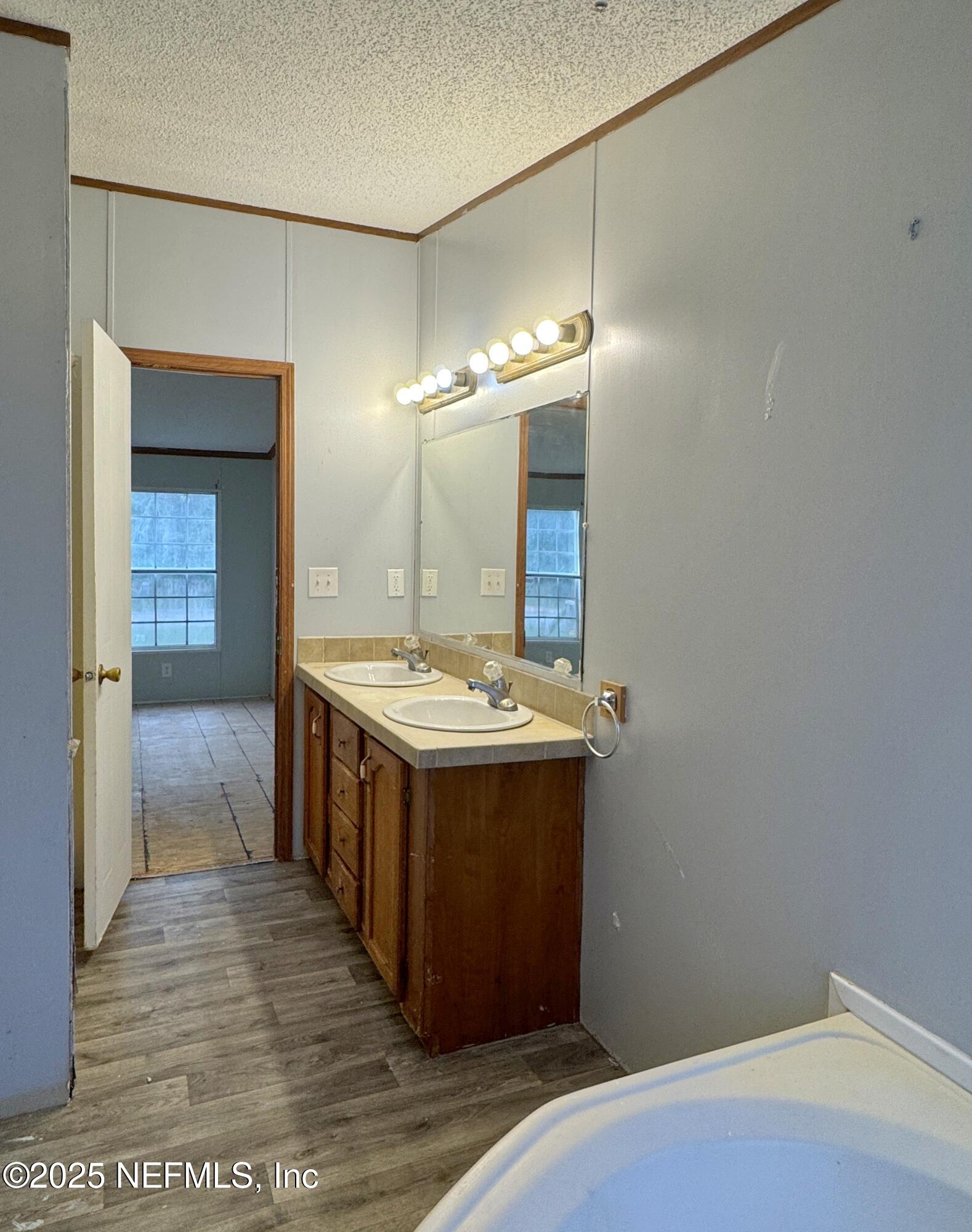 132 Long Road Interlachen, FL 32148 - Photo 14 of 21 a bathroom with a sink and a mirror