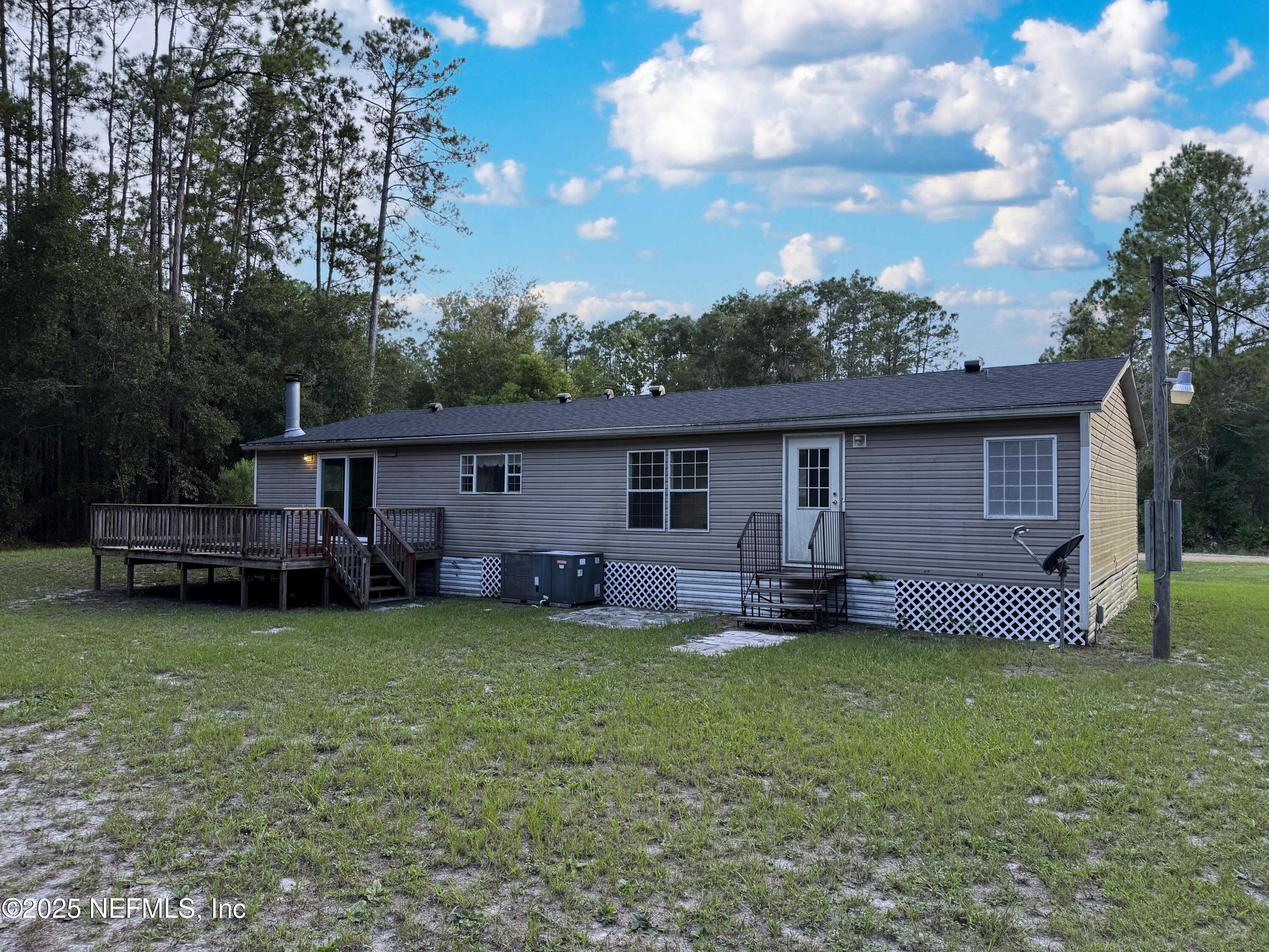 132 Long Road Interlachen, FL 32148 - Photo 3 of 21 a house that is sitting in the grass