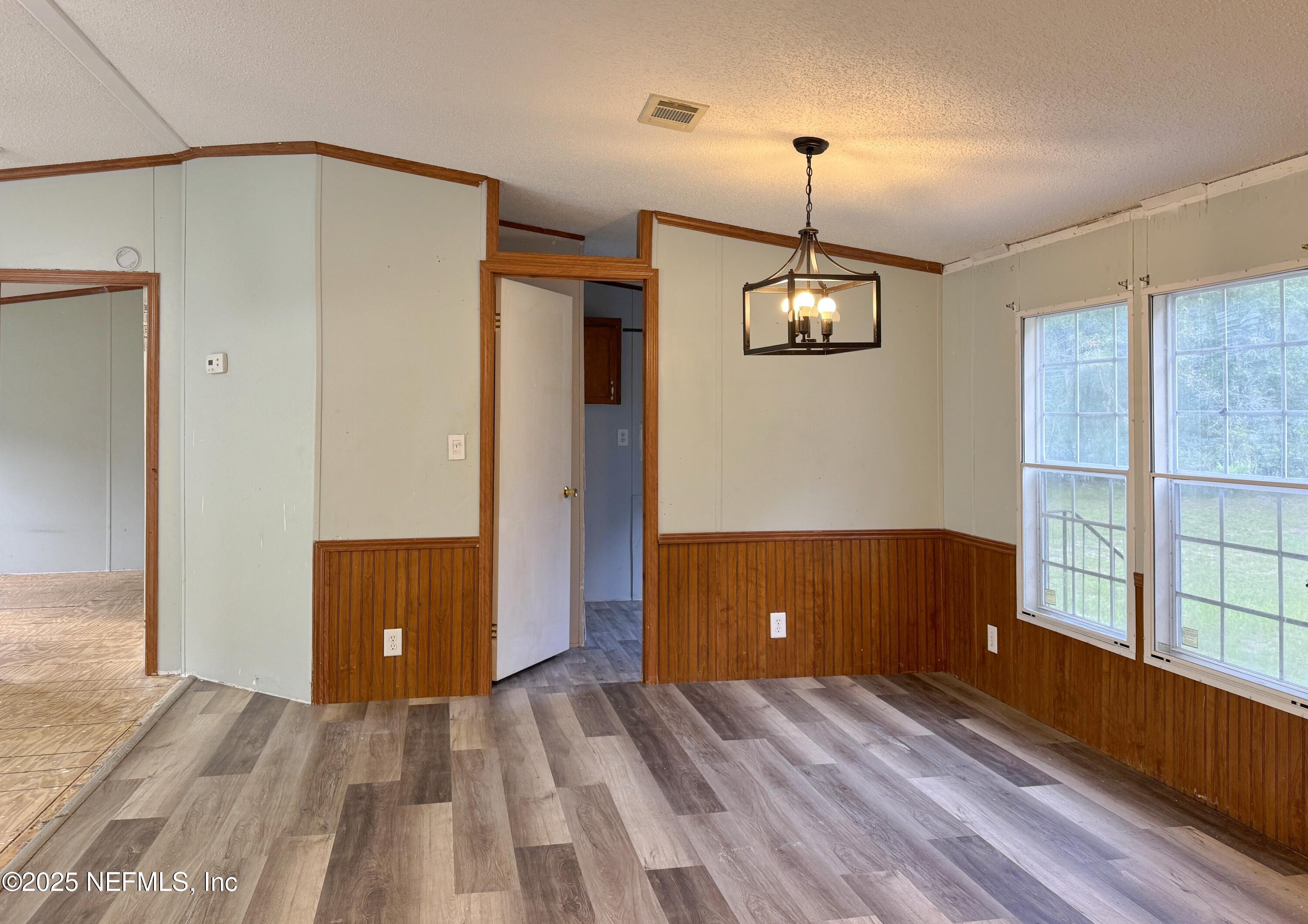 132 Long Road Interlachen, FL 32148 - Photo 9 of 21 a view of a room with window wooden floor and windows