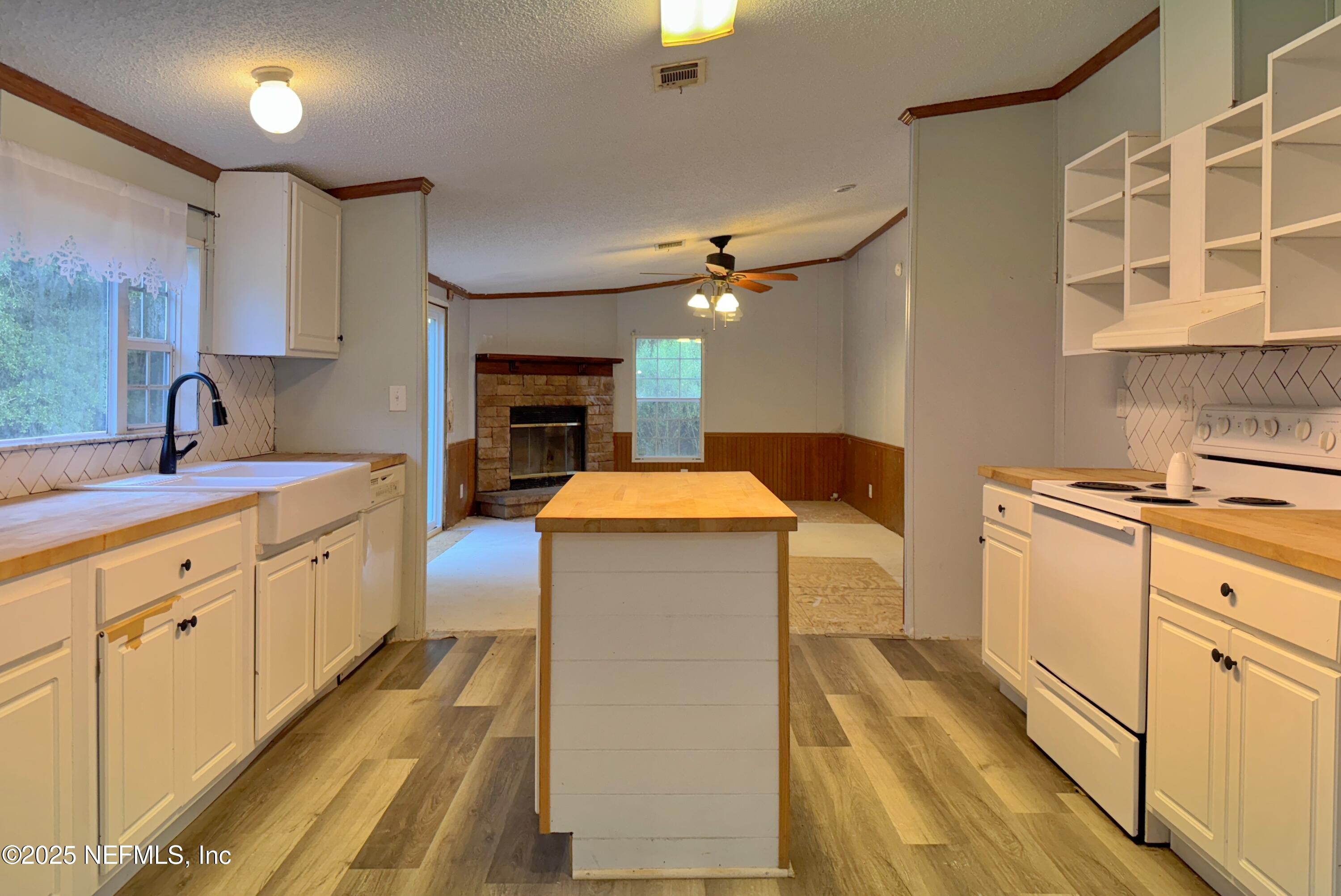 132 Long Road Interlachen, FL 32148 - Photo 10 of 21 a large kitchen with a large counter top space a sink stainless steel appliances and cabinets