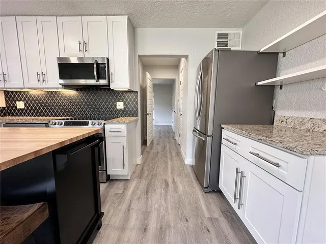 a kitchen with a sink stove and refrigerator