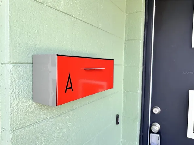 a kitchen view with wooden floor and stainless steel appliances