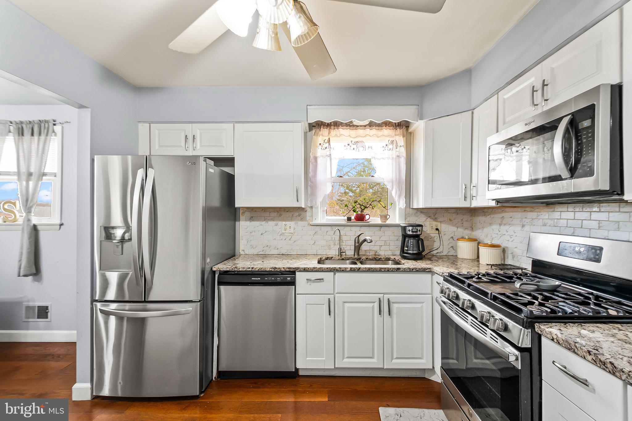 11411 Hermitt Street Clinton, MD 20735 - Photo 13 of 40 a kitchen with a stove a sink and a refrigerator