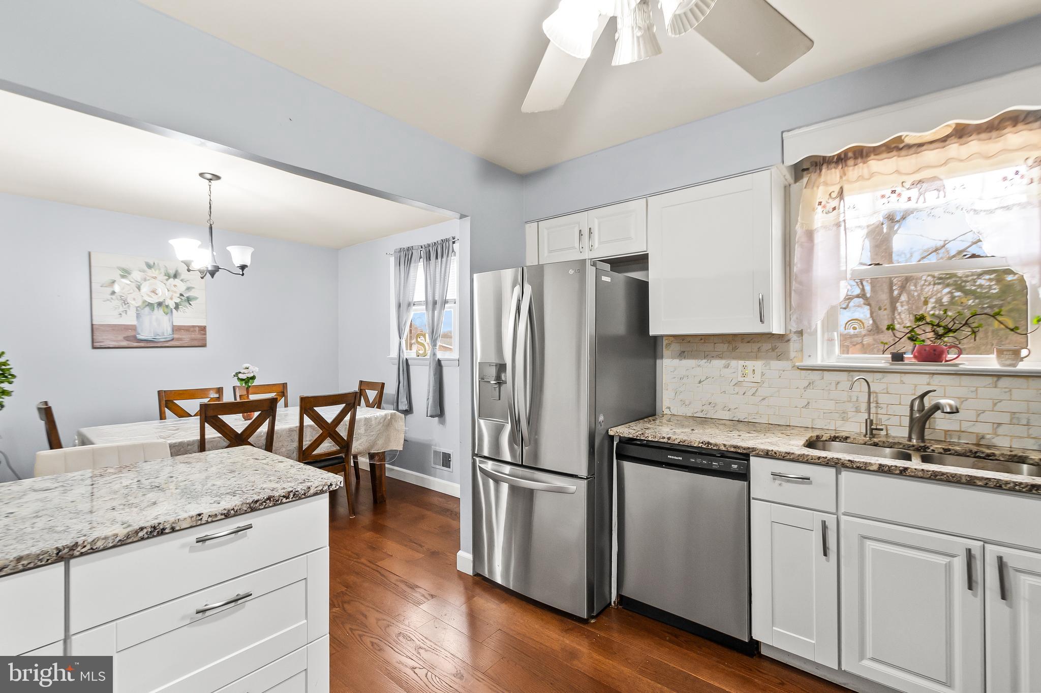 11411 Hermitt Street Clinton, MD 20735 - Photo 14 of 40 a kitchen with granite countertop stainless steel appliances a counter space and a window