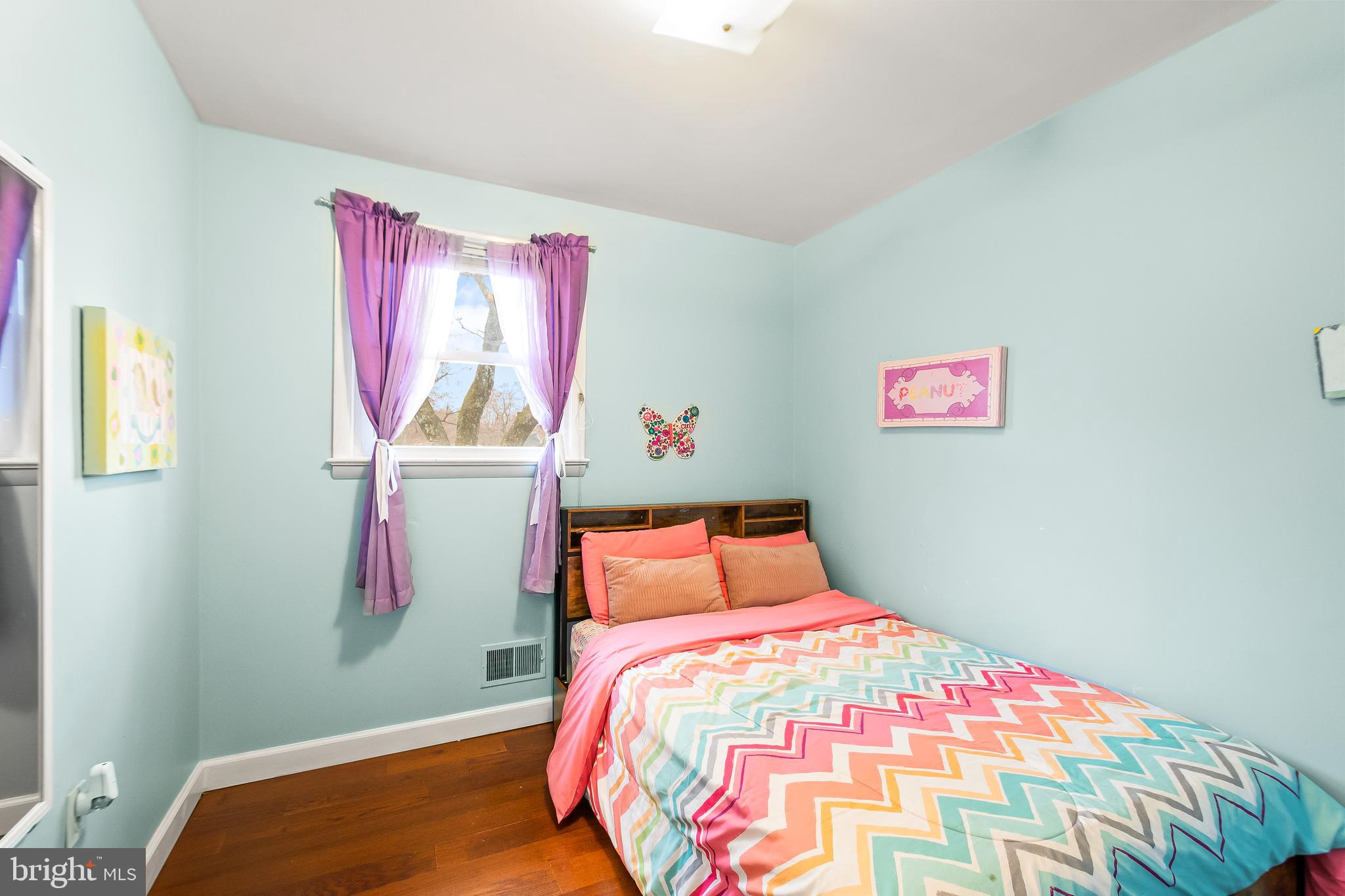 11411 Hermitt Street Clinton, MD 20735 - Photo 16 of 40 a bedroom with a bed and a painting on the wall