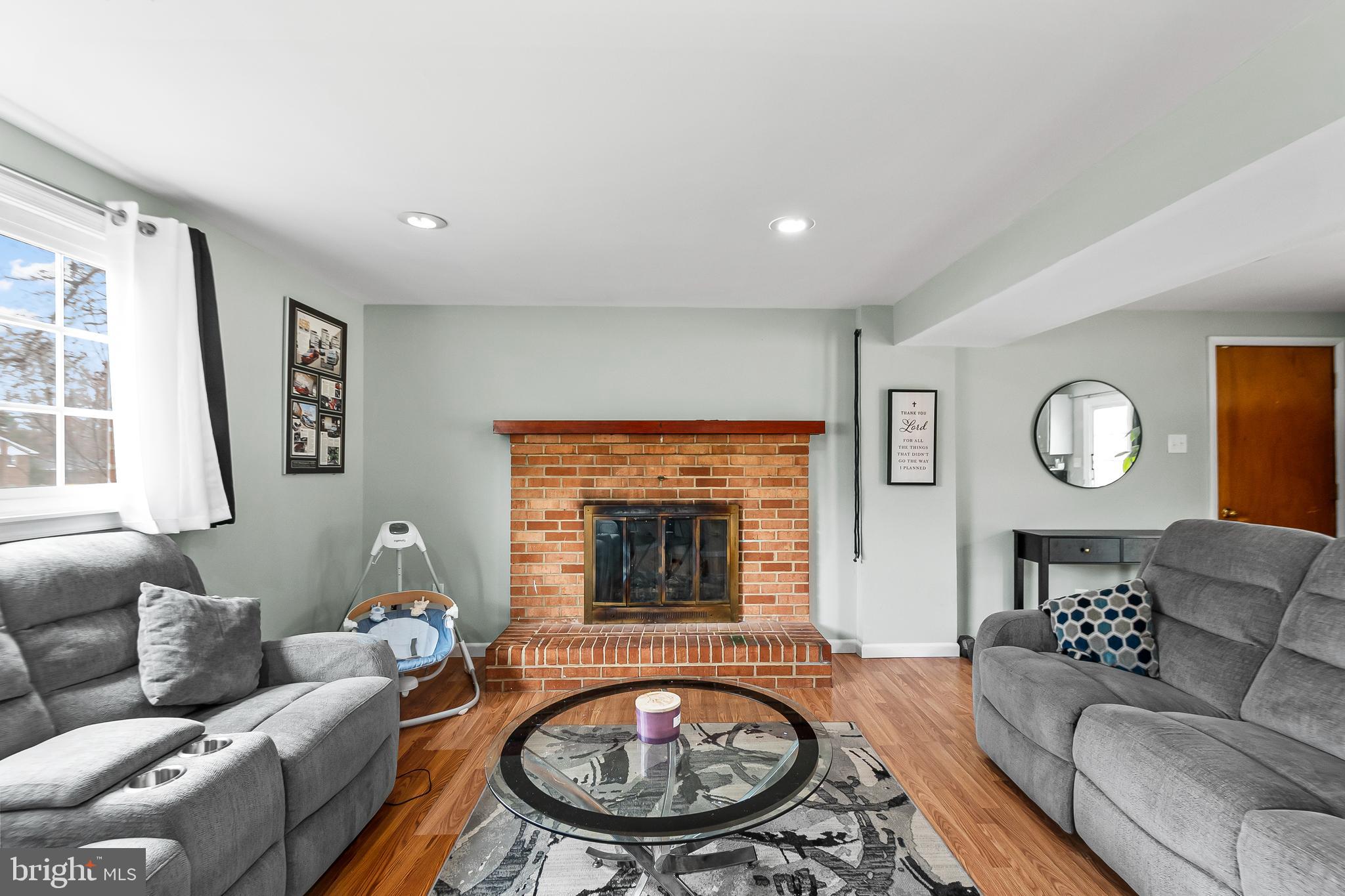 11411 Hermitt Street Clinton, MD 20735 - Photo 25 of 40 a living room with furniture a window and a fireplace