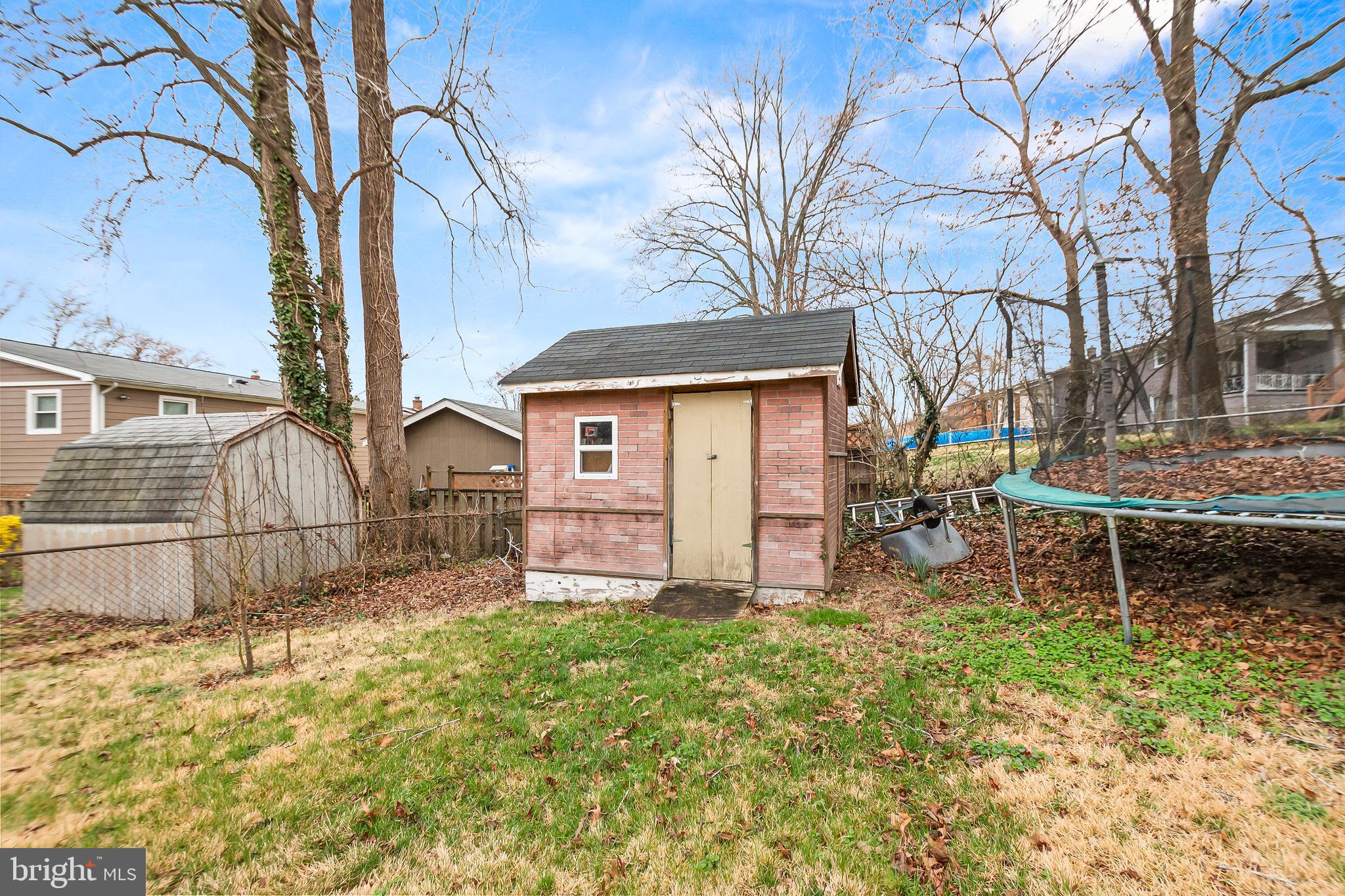11411 Hermitt Street Clinton, MD 20735 - Photo 39 of 40 front view of a house with a large tree and a table and chairs