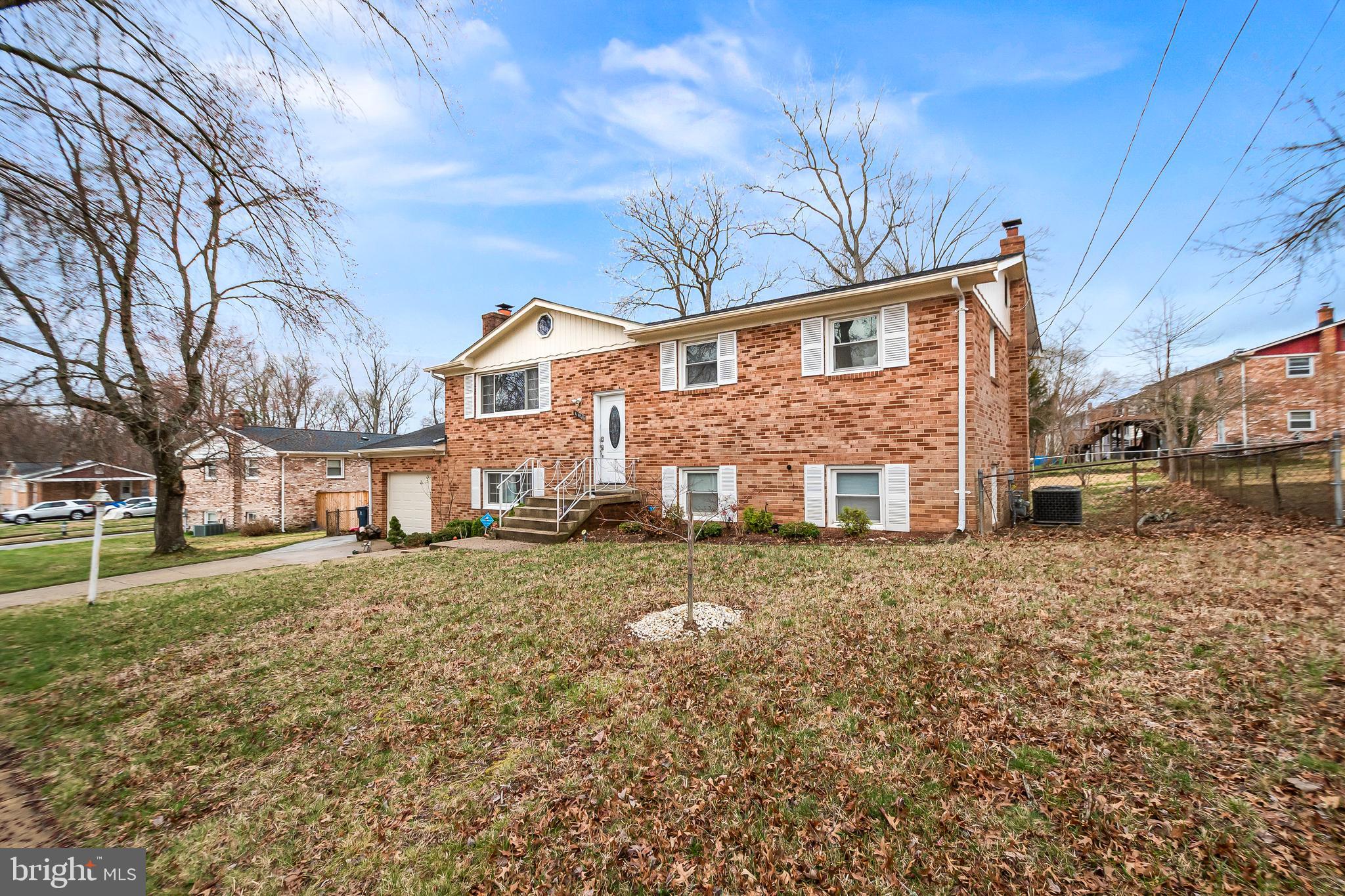 11411 Hermitt Street Clinton, MD 20735 - Photo 4 of 40 a view of a big house with a yard and large trees