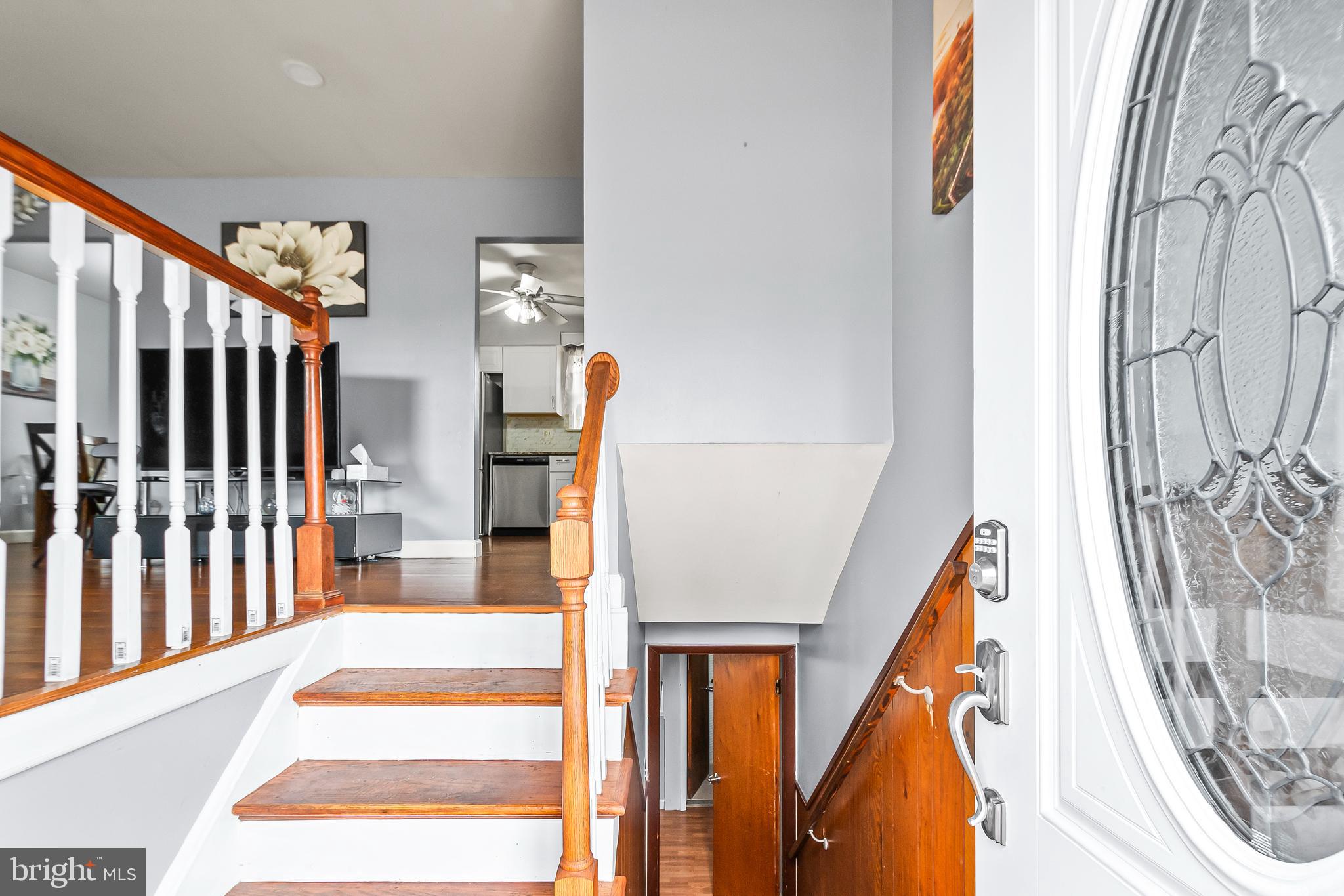 11411 Hermitt Street Clinton, MD 20735 - Photo 5 of 40 a view of staircase with lots of frames on wall and a large window