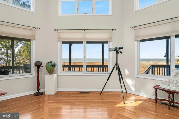 a large kitchen with kitchen island a island a stove a sink a dining table and chairs with wooden floor