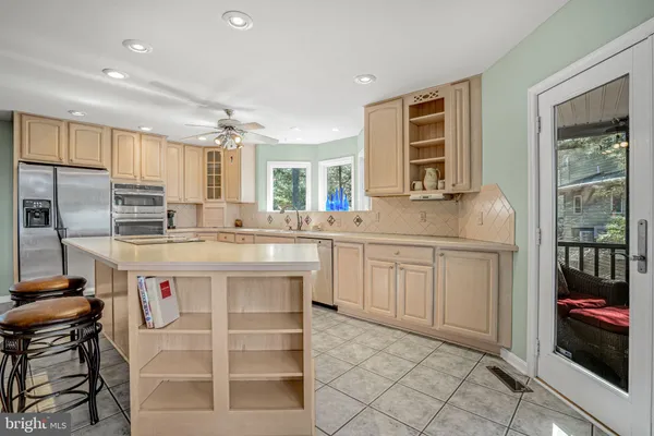 a dining room with furniture a chandelier and wooden floor