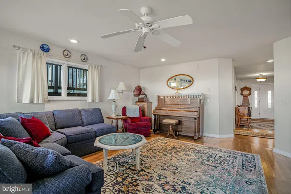 a bedroom with a bed a dresser and window