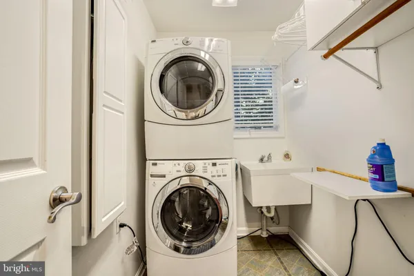 a spacious bedroom with a bed and a large window