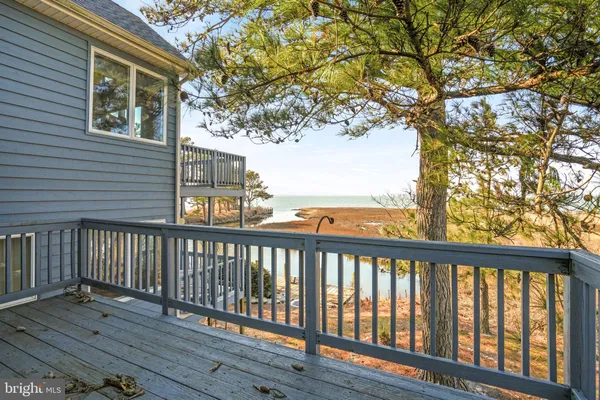 a balcony with wooden floor and fence