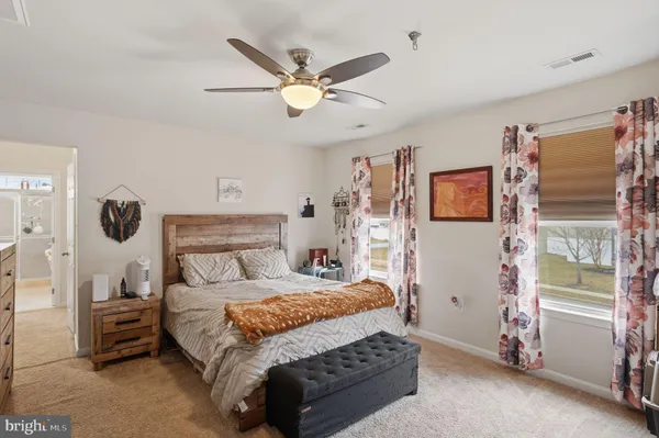 a bedroom with a bed and a ceiling fan