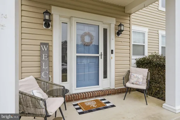 a balcony with furniture and a potted plant