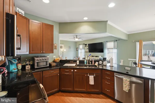 a kitchen with a sink appliances and cabinets