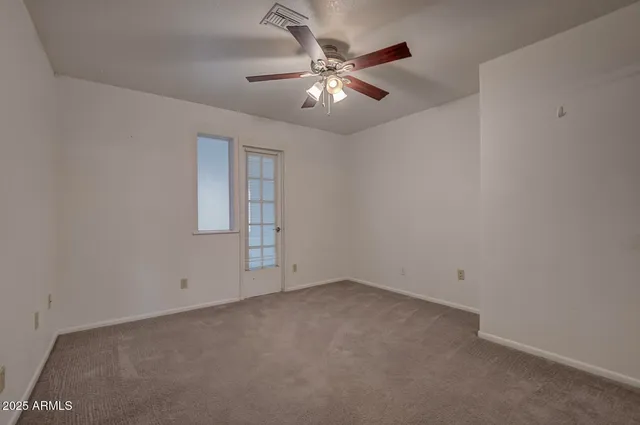 a bedroom with bed and a large window