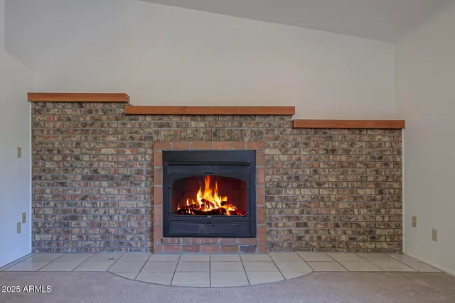 a spacious bathroom with a granite countertop sink a toilet mirror and vanity