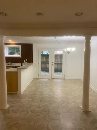 a kitchen with a sink a refrigerator and cabinets