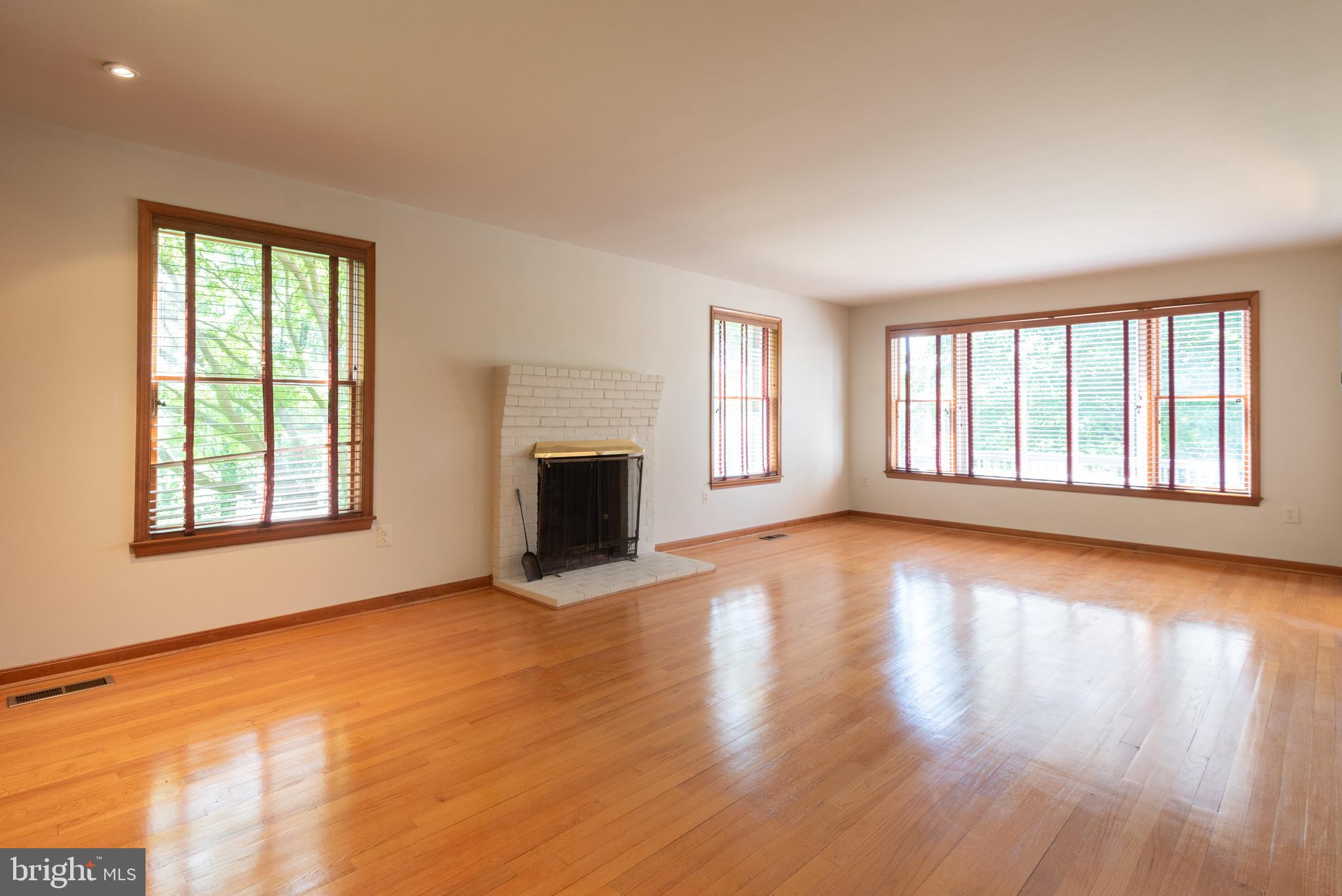 16120 Barnesville Road Boyds, MD 20841 - Photo 13 of 128 a view of an empty room with wooden floor and a window