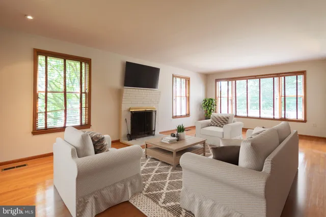 a view of a room with wooden floors and chandelier