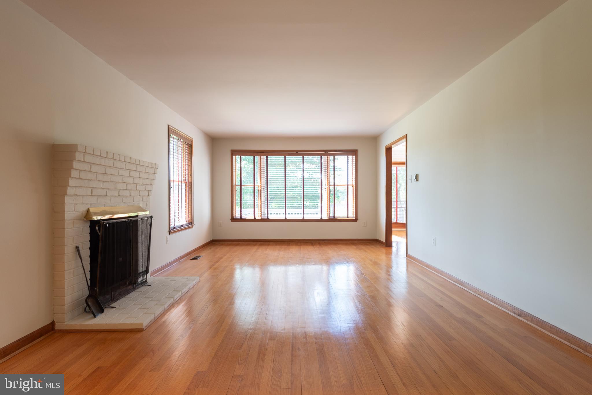 16120 Barnesville Road Boyds, MD 20841 - Photo 15 of 128 a view of an empty room with a fireplace and wooden floor