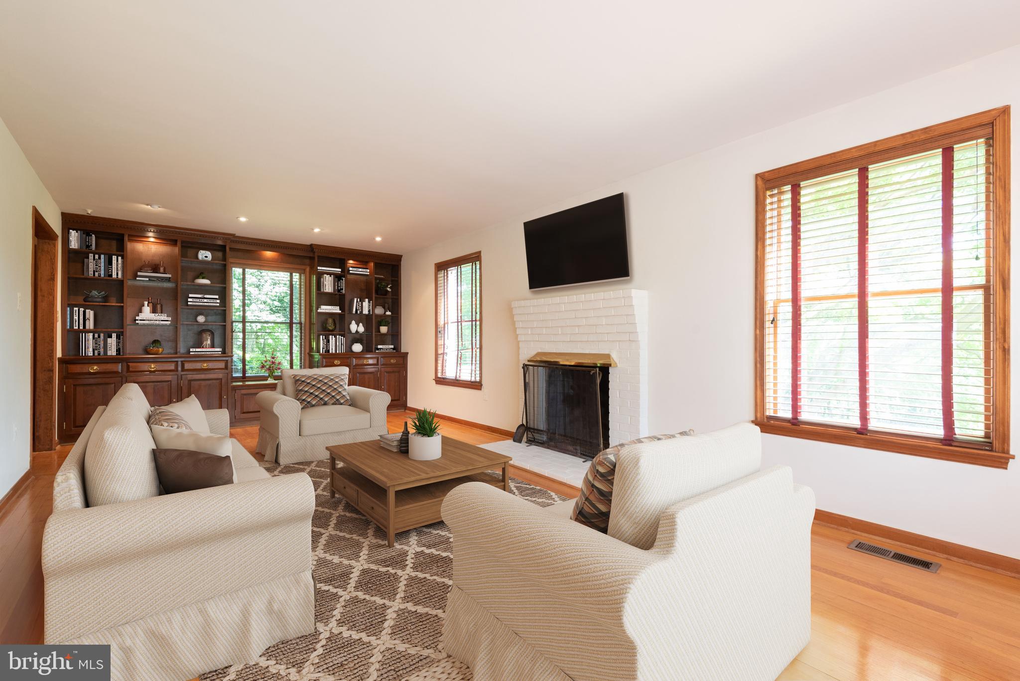 16120 Barnesville Road Boyds, MD 20841 - Photo 20 of 128 a living room with furniture a flat screen tv and a fireplace