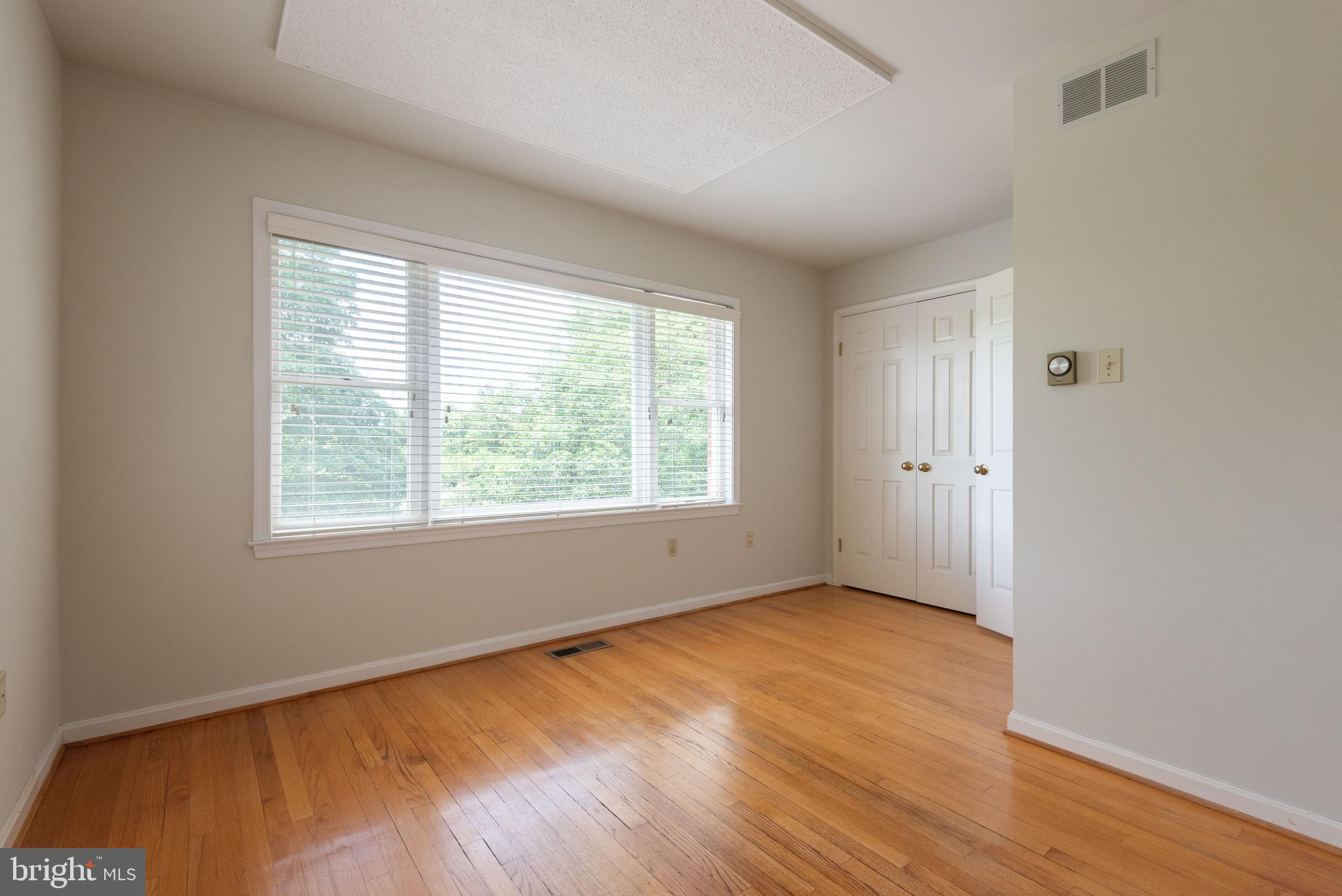 16120 Barnesville Road Boyds, MD 20841 - Photo 46 of 128 an empty room with wooden floor and windows