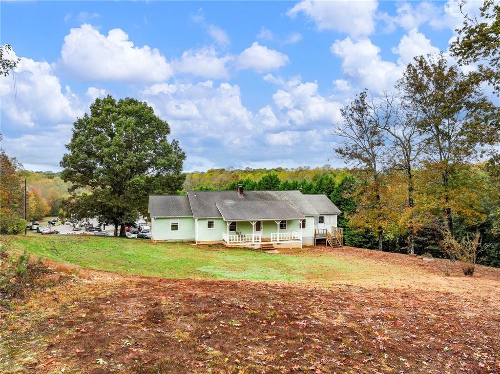 a view of a house with yard and sitting area