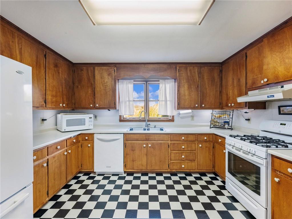 849 Blacksnake Road Mount Airy, GA 30563 - Photo 11 of 68 a kitchen with a sink a stove top oven a refrigerator and cabinets