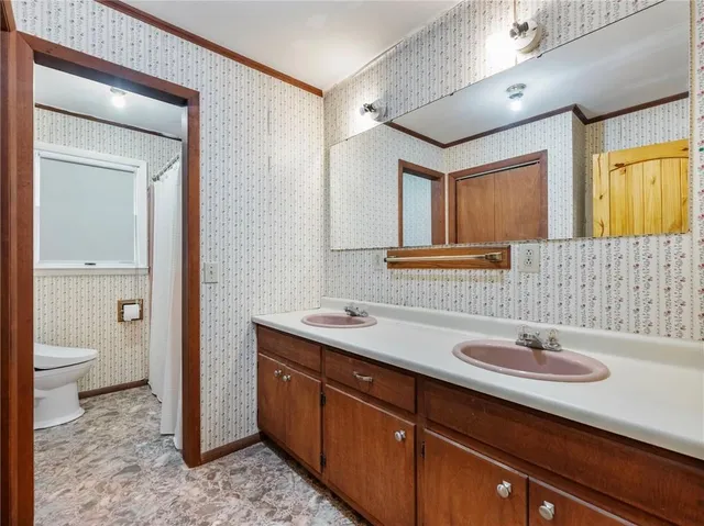 a bathroom with a granite countertop sink a mirror and a shower