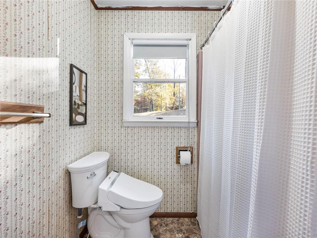 849 Blacksnake Road Mount Airy, GA 30563 - Photo 15 of 68 a white toilet sitting next to a bathroom sink