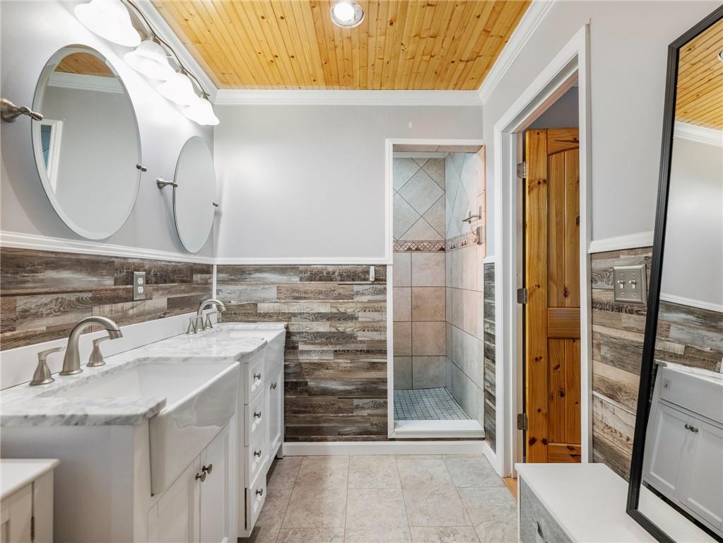 849 Blacksnake Road Mount Airy, GA 30563 - Photo 19 of 68 a bathroom with a granite countertop sink a mirror and a shower