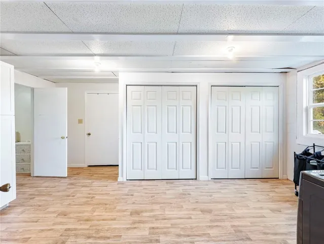 a view of a patio with table and chairs with wooden floor and fence