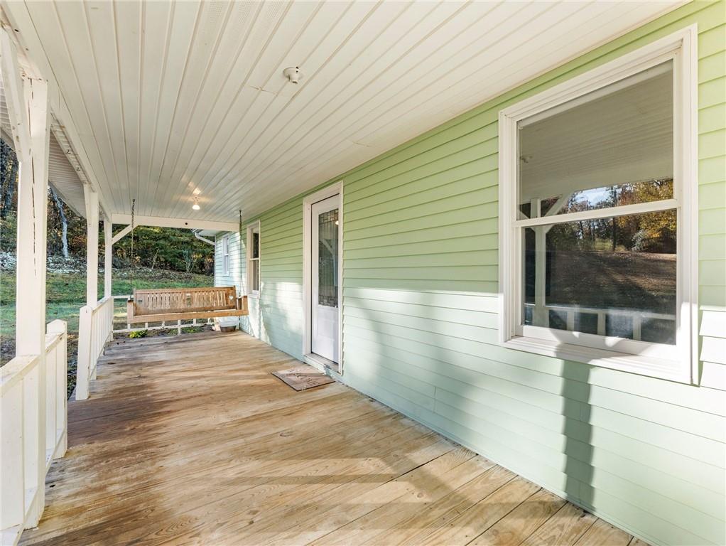 849 Blacksnake Road Mount Airy, GA 30563 - Photo 32 of 68 a view of a patio with table and chairs with wooden floor and fence