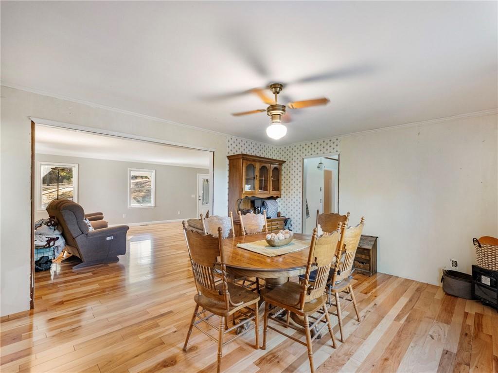 849 Blacksnake Road Mount Airy, GA 30563 - Photo 9 of 68 a view of a dining room with furniture and wooden floor