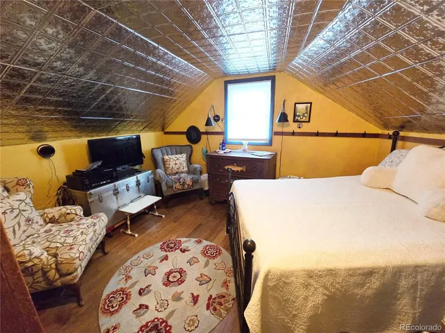 a bed room with a bed and a television