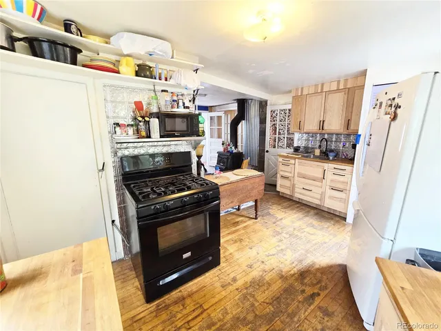 a kitchen with refrigerator and cabinets