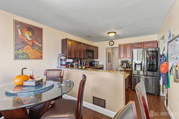 a kitchen with stainless steel appliances dining table and chairs
