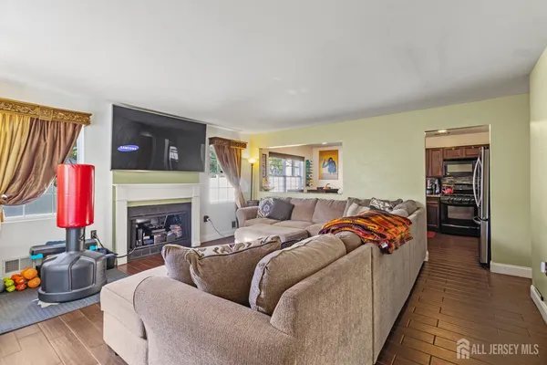 a living room with furniture a fireplace and a flat screen tv